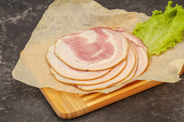 Sliced Pancetta sausage over board