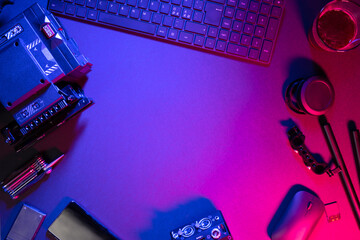 Overhead view of computer parts with coffee and video camera on illuminated table
