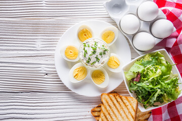 boiled chicken eggs on a white wooden rustic background