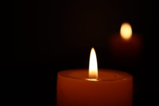 Candle black background of mourning funeral moment of silence