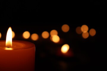 Candle black background of mourning funeral moment of silence