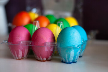 colored eggs in the egg tray