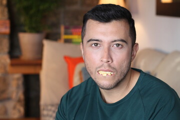 Young ethnic man with unhealthy teeth 
