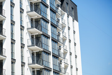 Large panoramic plastic windows. Facade of a new building in the house during construction work. Multi-storey building during construction