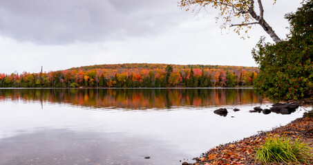 Lake reflecting autumn trees on a lake in Northern Michigan