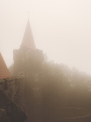 View on an aged medieval castle in a fog