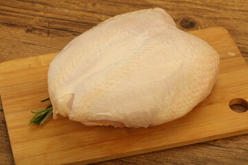 Raw whole chicken breast with skin