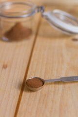 Measurement spoon with cinnamon powder close up