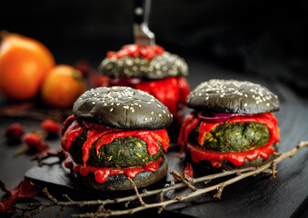 Halloween black burgers on dark background close up view. Halloween food idea for  party