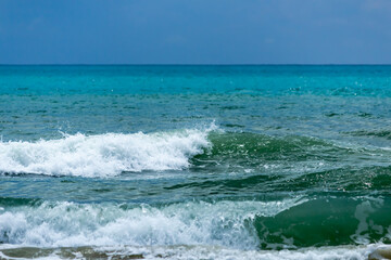 wave on the turquoise sea, amid storm clouds