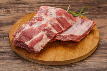 Raw pork ribs served rosemary