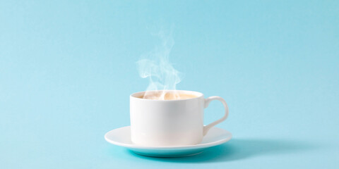 Steaming coffee cup on pastel blue background. White сoffee cup with steam. Front view, copy space