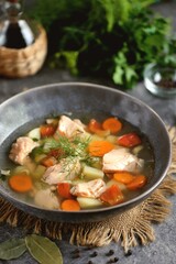 Vegetable soup with salmon, potatoes, onions and carrots. Healthly food.