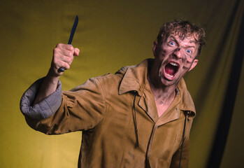 The man with a knife in a hand. Closeup. Anrgy man. 
