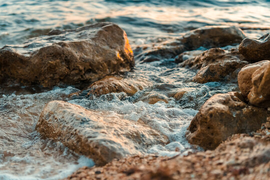 Beautiful waves hitting the rocks on the shore of a sea or ocean, photos with a short exposure