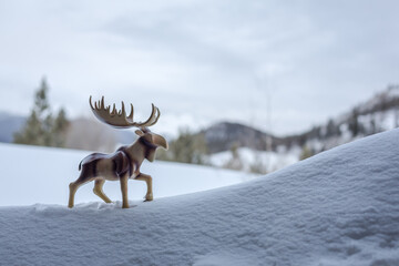 Wooden moose sculpture takes a walk uphill in the snow. Mental health awareness