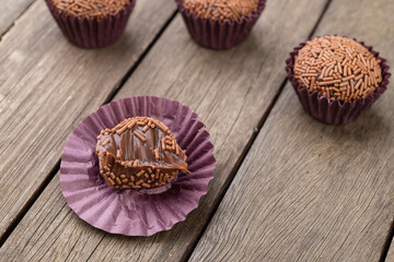 Typical brazilian brigadeiros, various flavors over wooden table