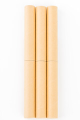 Empty brown cardboard roll tube on white background.