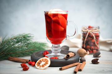 Happy New Year and merry Christmas, festive background with fruit tea with cinnamon on a light wooden background. Horizontal orientation, side view.