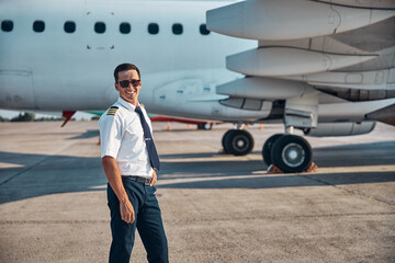 Cheerful handsome pilot relaxing outdoors after flight © Svitlana