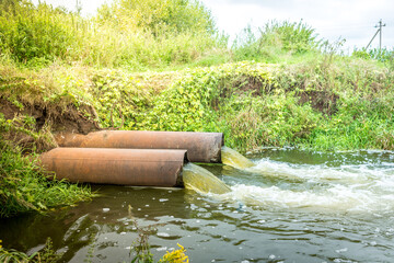 water flows out of the drain/Ecology. Sewage pipes pollute the water in the river