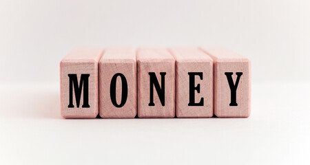 Concept word forming on wooden cube on white background - money