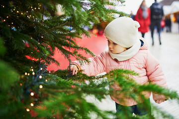 Adorable toddler girl on Christmas market in Paris
