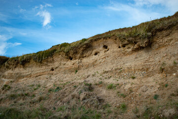 Fototapeta na wymiar landslide on cliff, clay and sand