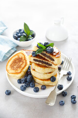 Fluffy souffle pancakes with chocolate filling and fresh blueberry for breakfast.