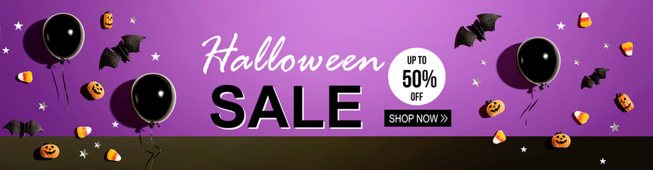 Halloween sale banner with black balloons and Halloween decorations