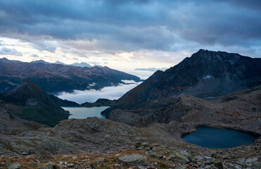 alpine lakes at dawn against the background of mountains with dark clouds