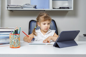 little girl on a remote online lesson with a teacher. remote learning during the COVID-19 pandemic