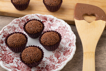 Typical brazilian brigadeiros with spoon over wooden table