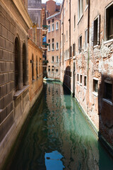 Fototapeta na wymiar Traditional Venice Cityscape with narrow canal. Vertical image