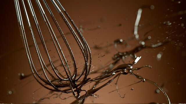 Freeze motion of wire whisk rotating hot melted chocolate