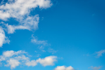 Blue sky background with a tiny clouds