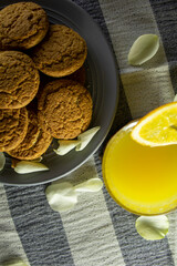 plate with biscuits and a glass of juice