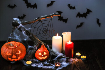 Halloween pumpkins with candles, cobwebs, bats. Layout of a Halloween poster. Halloween decor with...