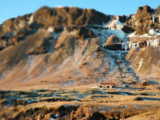 A lonely house at the foot of the mountains in Iceland. Incredible landscapes of nature. Life for a social phobia