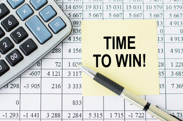 Text Time to win on a yellow sheet on a table next to a calculator, pen, background with numbers . Business Concept