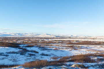 Iceland's incredible fields and plains landscape in winter. The ground is covered with snow. Large spaces. The beauty of winter nature