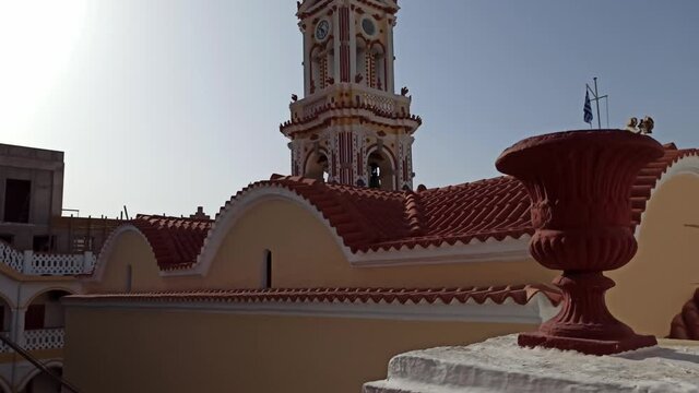 Rhodes, Greece - September 27, 2020: Tilt up shot of Holy Monastery of Archangel Michael Panormitis against clear blue sky