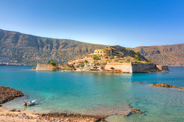 Naklejka premium View of the island of Spinalonga with calm sea. Here were isolated lepers, humans with the Hansen's desease, gulf of Elounda, Crete, Greece. 