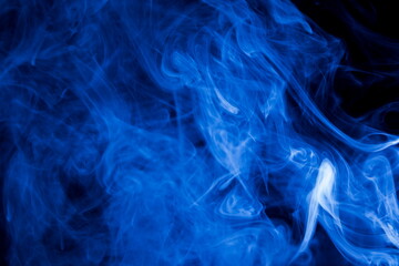 Blue smoke on black background