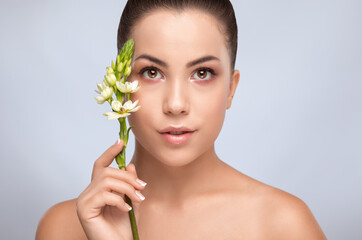 Portrait of a beautiful charming brunette woman with healthy clean skin and fresh make-up. Looking...
