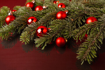 Fototapeta na wymiar Christmas festive background with coniferous branches and Christmas balls