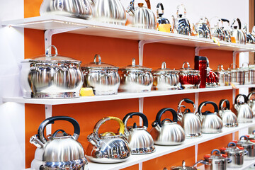 Enameled kitchen stock pots and teapots in store