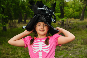 Happy Halloween. Portrait of a cute little child girl in a witch hat