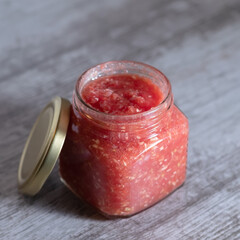 Garlic and horseradish appetizer in a transparent jar. Close-up. Preparation for the winter. Cold prevention.