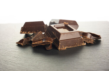 Blocks of chocolate bar on dark slate background